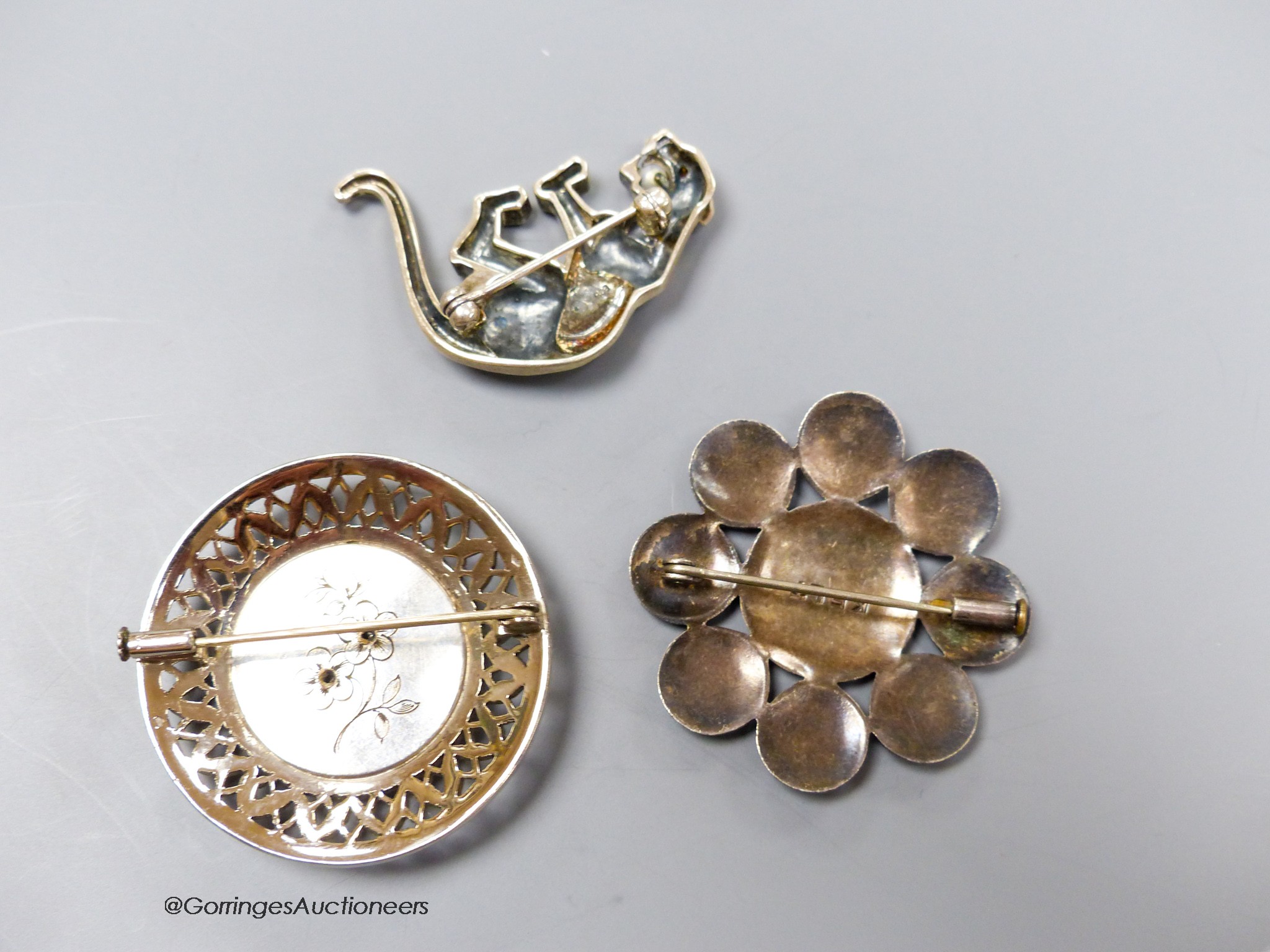 Three assorted brooches including a French white metal, marcasite and enamel, 40mm.